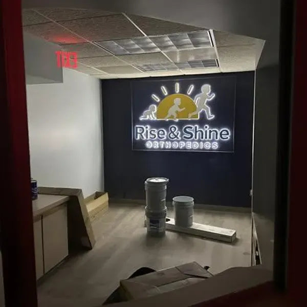 Illuminated 3D letter sign installed on a commercial fit-out storefront